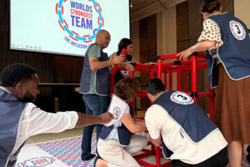 Colleagues working together to solve strategic team building activities
