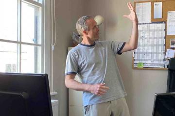 man in front of computer doing haka