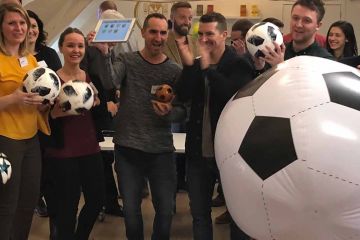 group of people playing team building indoor soccer activity quickfire