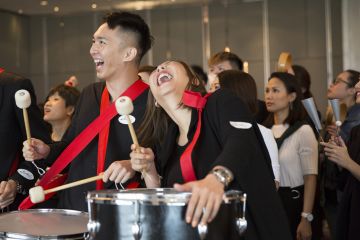 employees collaborate to complete beatswork team building activity