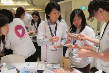 women collaborating to complete bean around the world team building activity