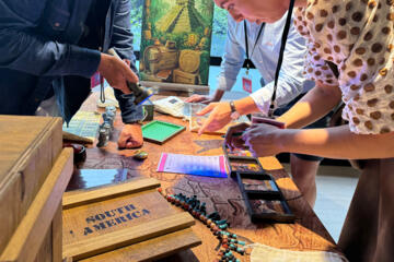 Team member working through a puzzle in the Passport to Adventure experience.